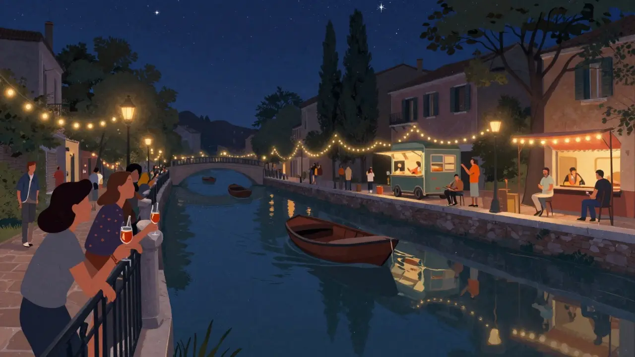 Nighttime view of Navigli canal with string lights, people on the waterfront, and boats drifting under the stars.